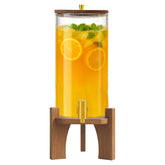 Verssure glass drink dispenser with stand showcasing colorful beverages at a gathering