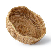 YANGQIHOME rattan bread basket with round scalloped edge on a wooden surface for display