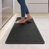 YDKGL standing mat in black reduces foot fatigue during cooking tasks.