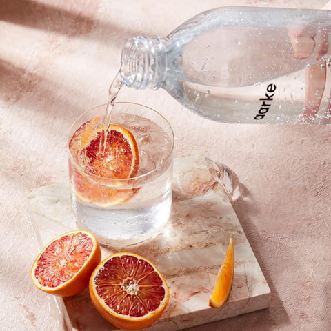 Bottle with sparkling water illustrates ready-to-refill convenience.