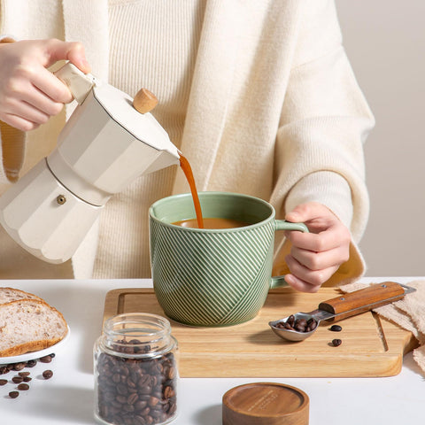 Adewnest green 32oz mug showing textured surface for grip.