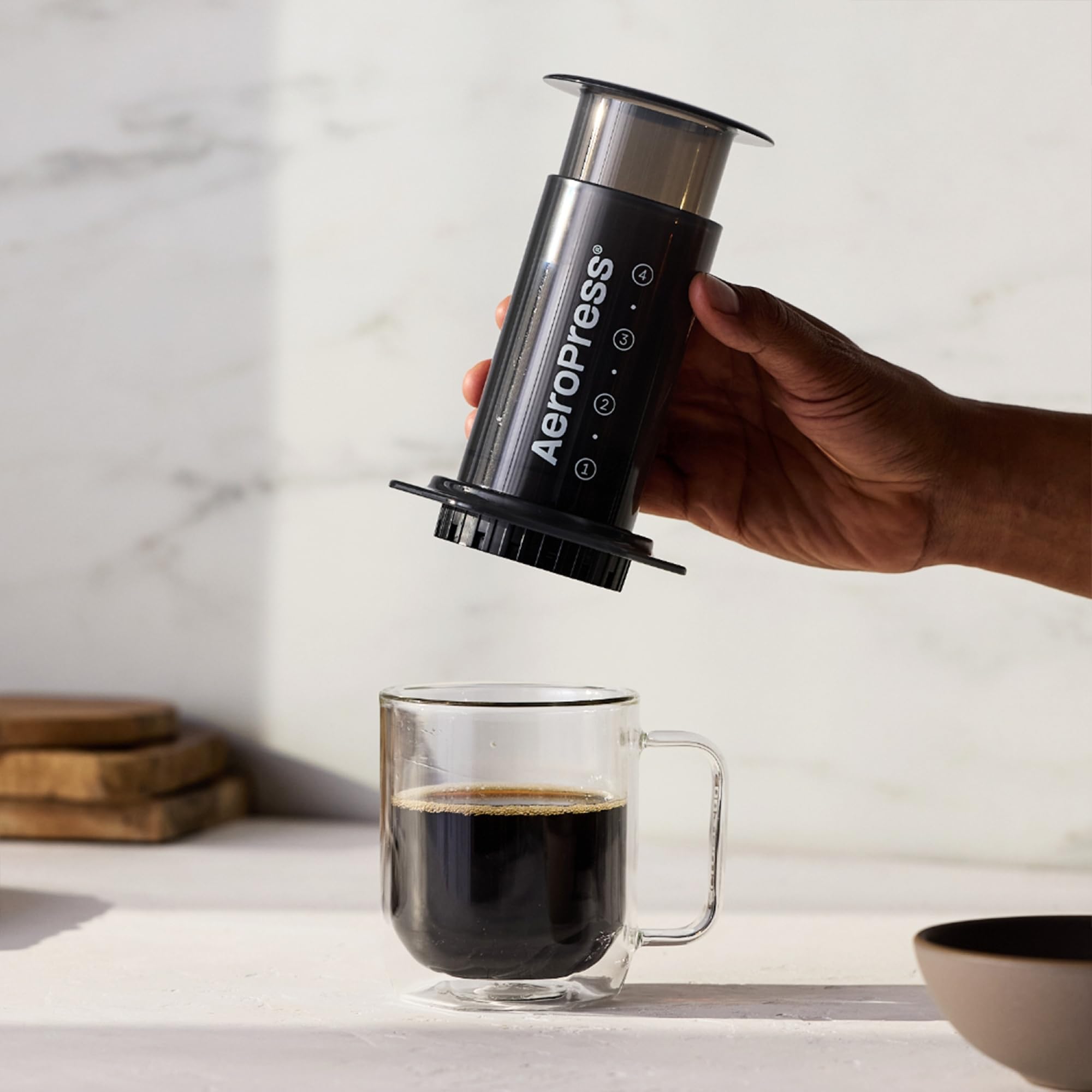 AeroPress Original portable design shown in a backpack-friendly scene