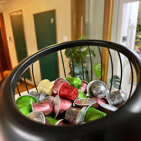 AIYICIII multi-use storage for tea bags and snacks beside coffee pods.