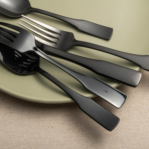 Alata Kate Black Mirror on table with stemware, complementing any dinnerware setup.