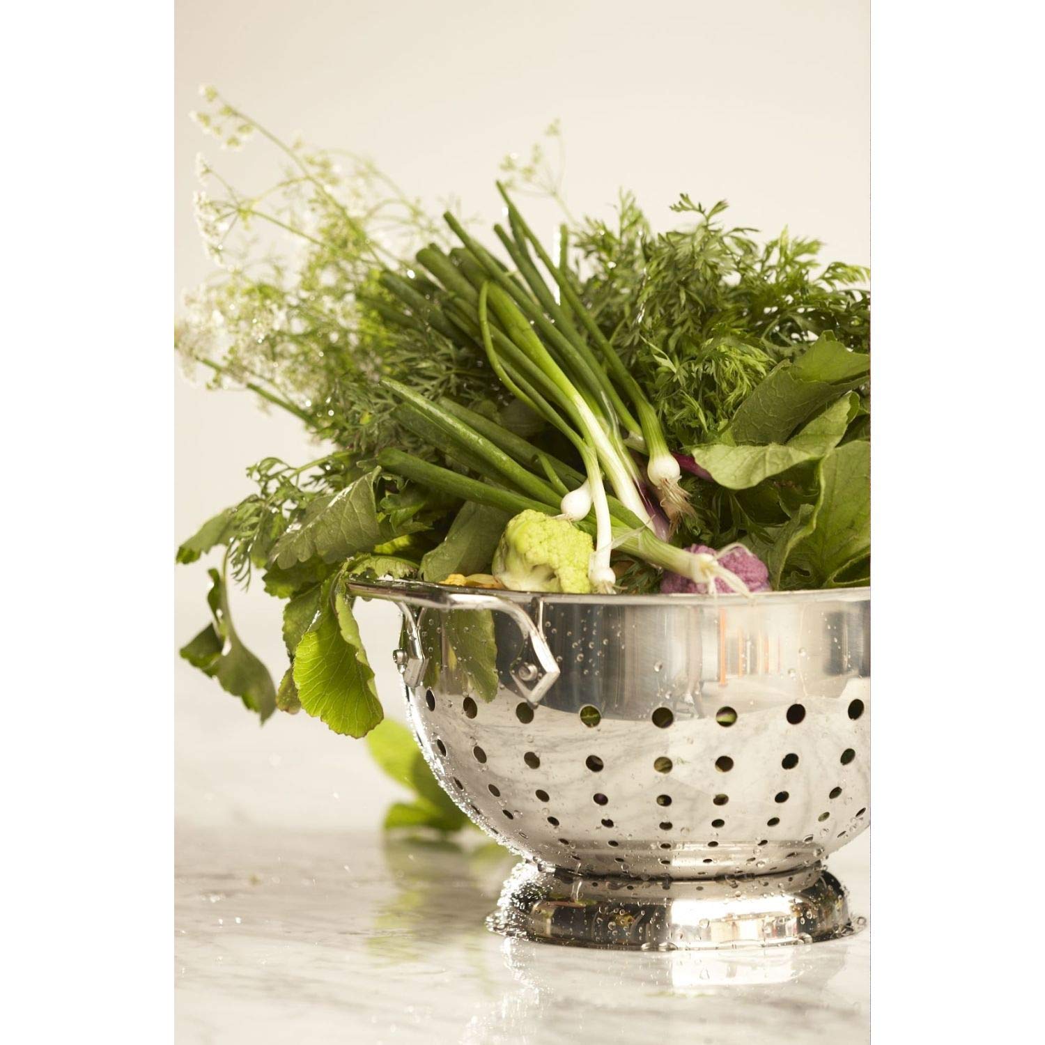 All-Clad colander with graduated holes speeds drainage and air circulation.