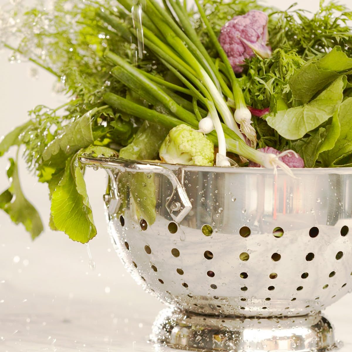 All-Clad colander features rolled edges for controlled, drip-free pouring.