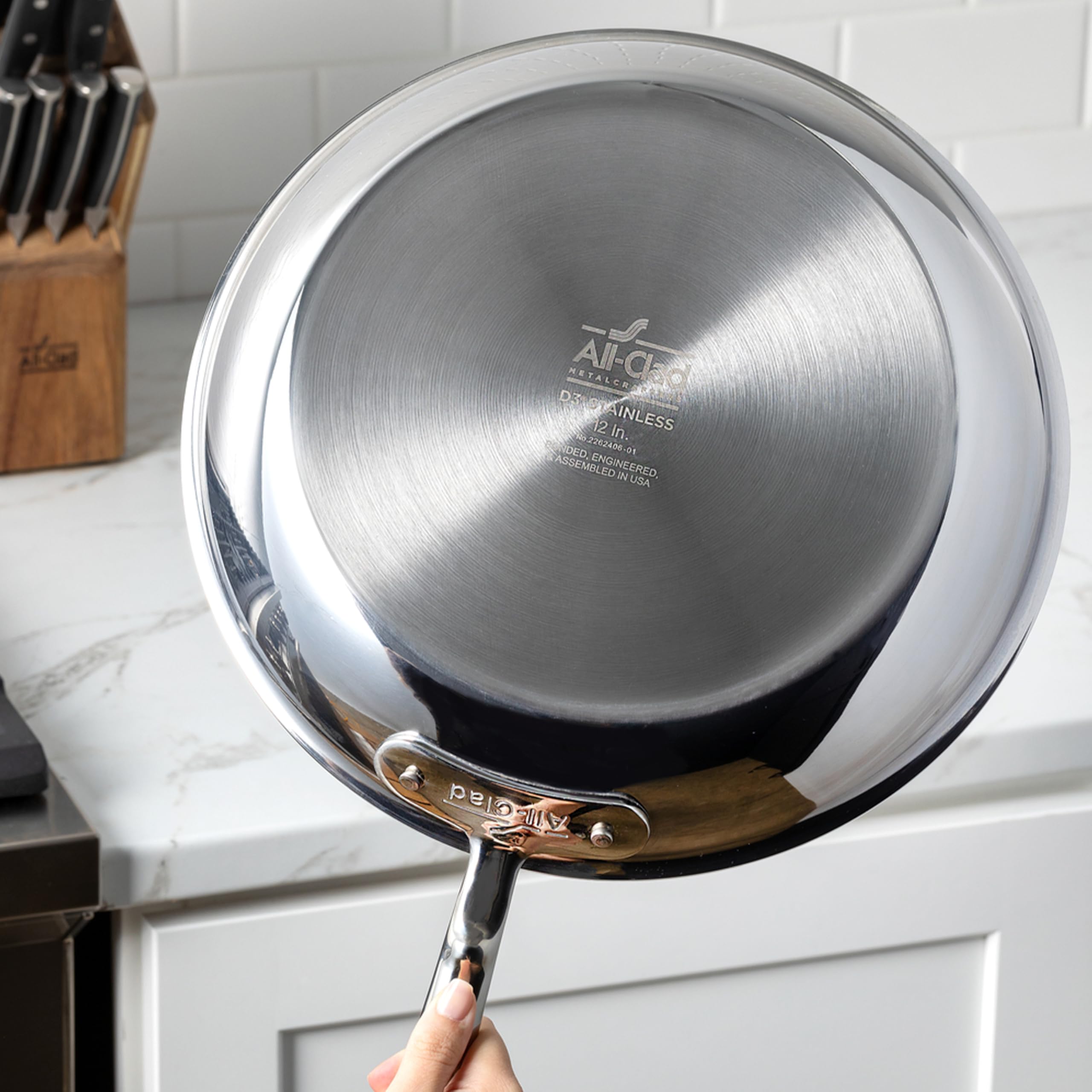 All-Clad D3 1.5-quart saucepan on induction stove for versatile heating.