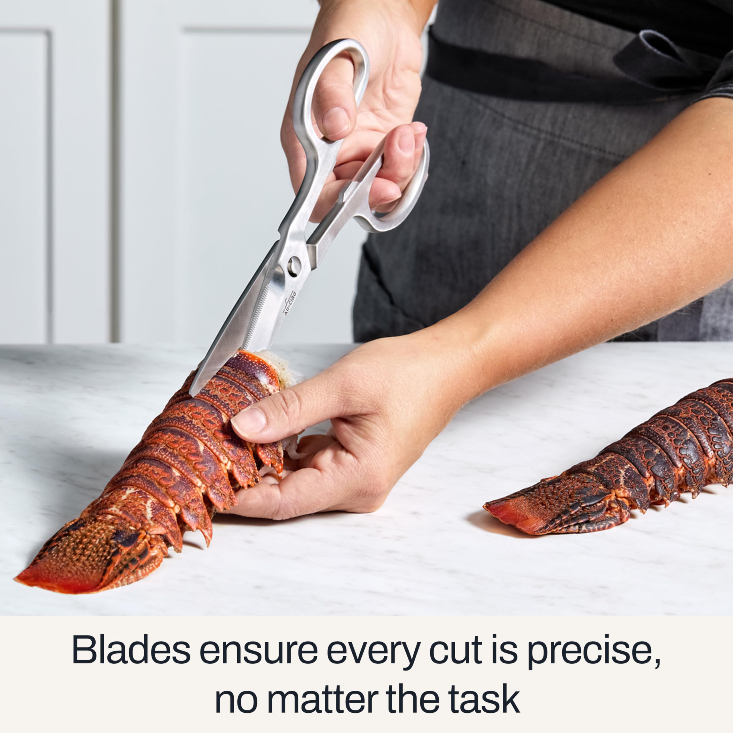 All-Clad shears snipping fresh herbs with precise, clean cuts.