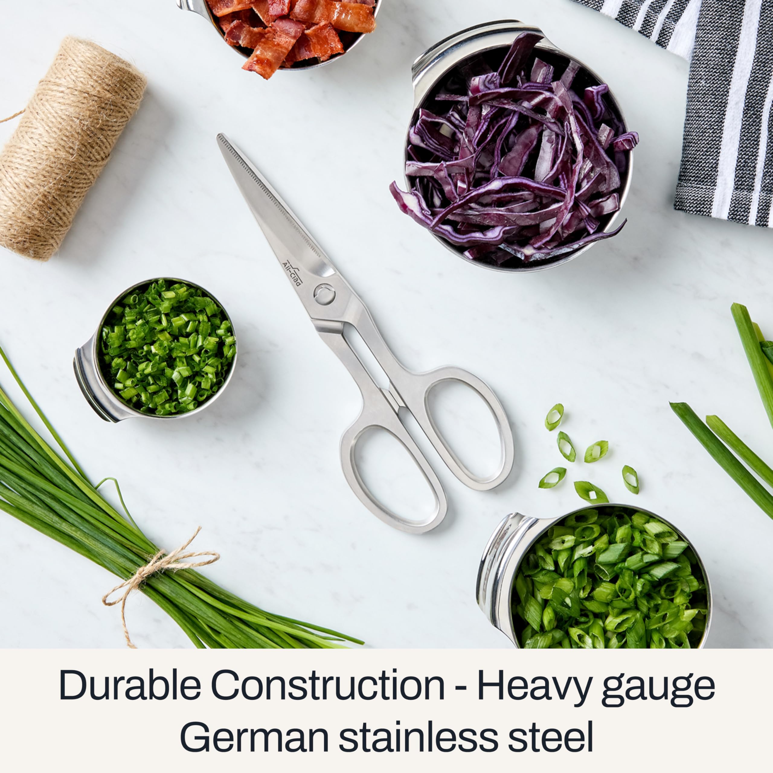 All-Clad kitchen shears cutting poultry and shellfish with ease in meal prep.