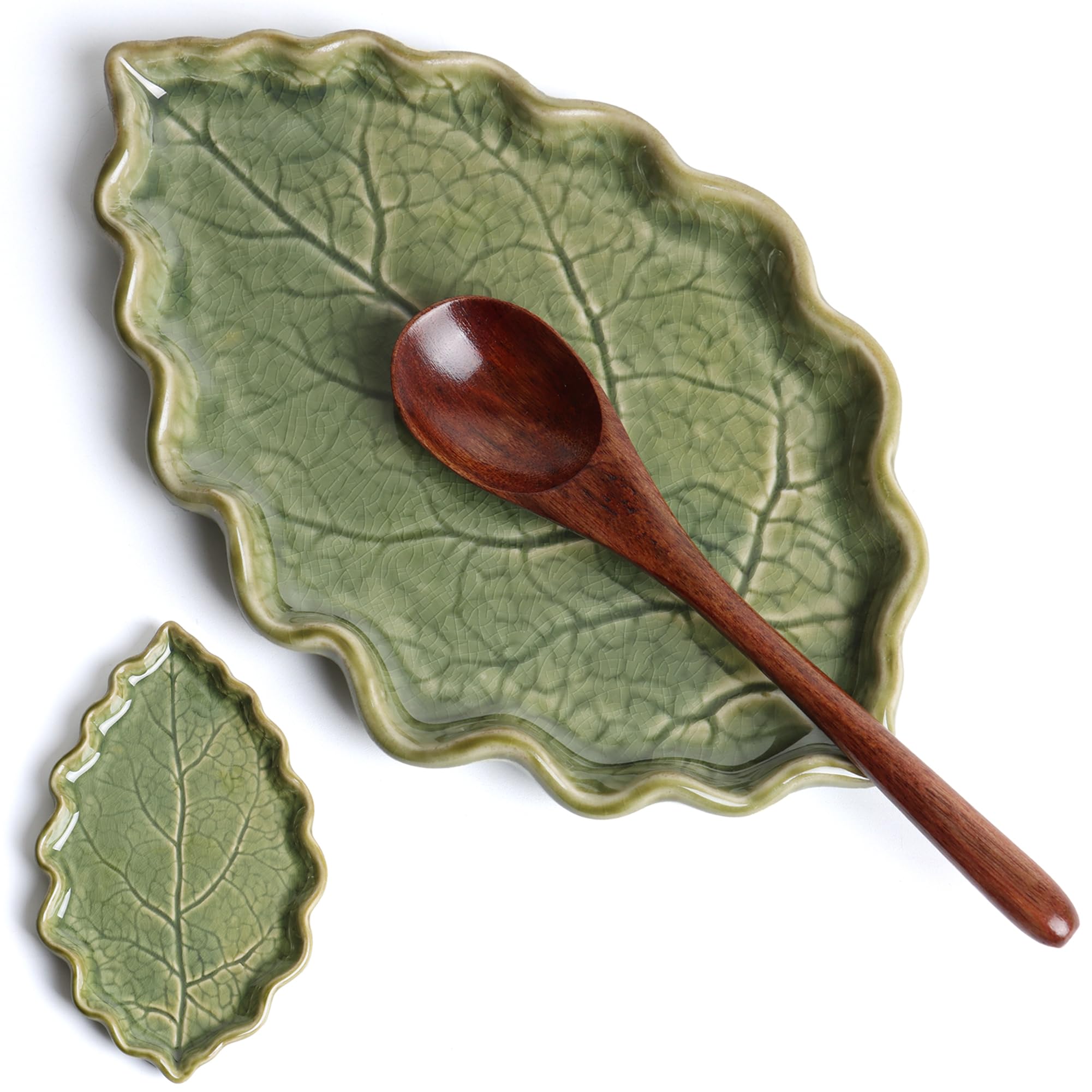 Anoonse ceramic spoon rest with green leaf design on countertop.