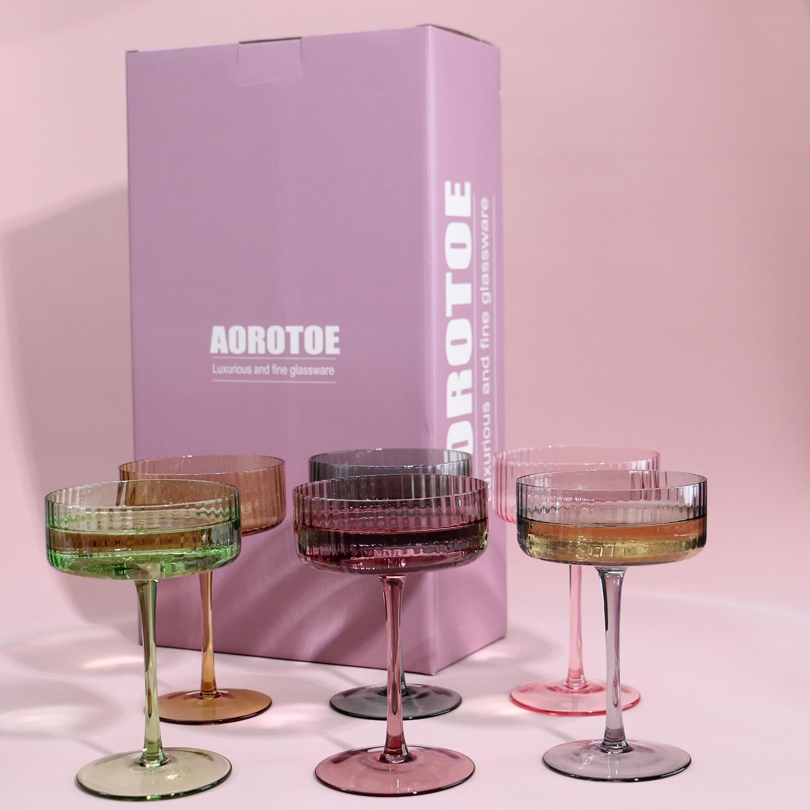 Pink and yellow AOROTOE glassware adds color to a home bar setup.