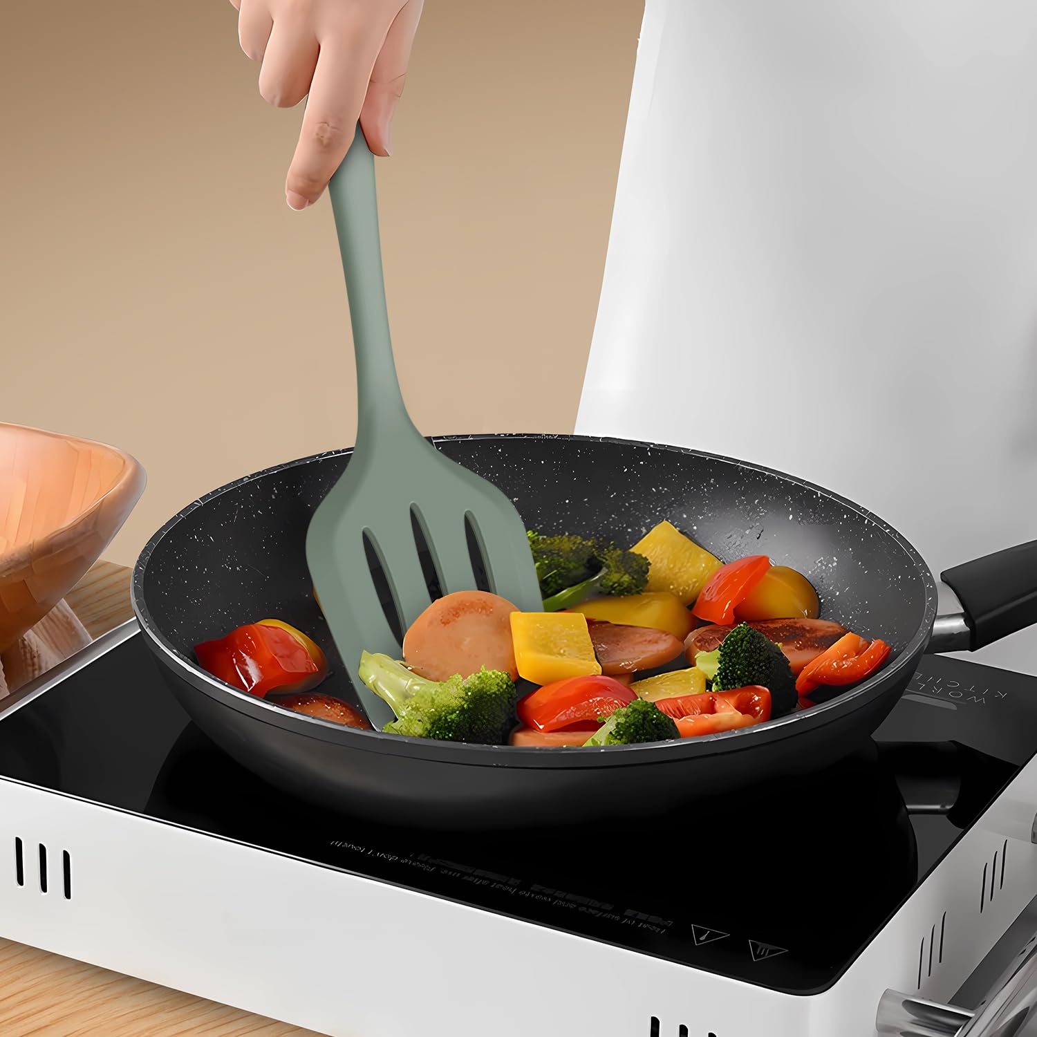AOTHOD slotted spoon for draining pasta while cooking.