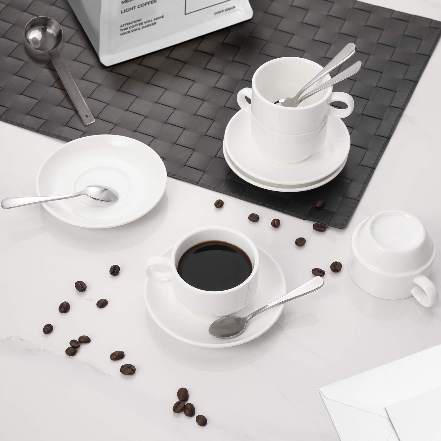 AOZITA stackable porcelain espresso mugs saving space on a shelf.
