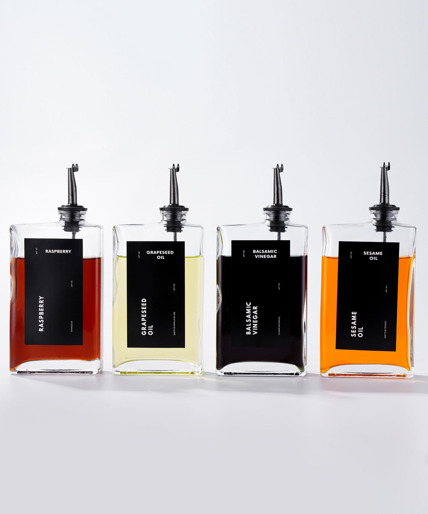 APT 1101 four glass bottles dispenser set on counter for precise pouring.