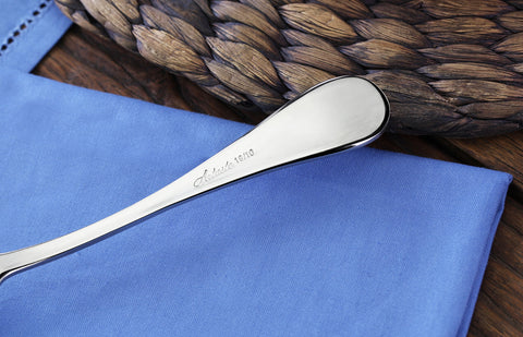 Artaste Rain dinner spoon next to plate ready for serving