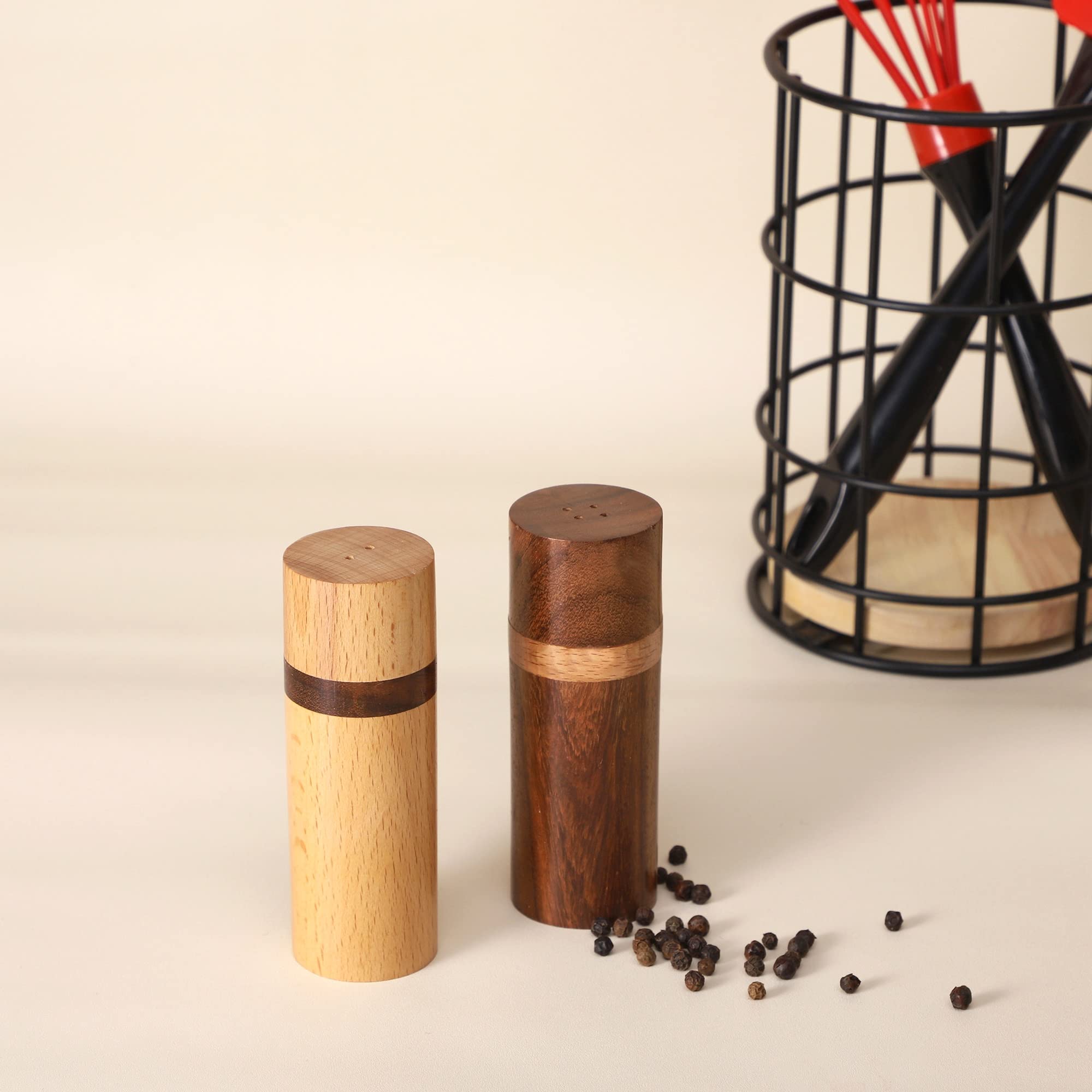 Artistic India salt and pepper set on table showcases balanced contrast.
