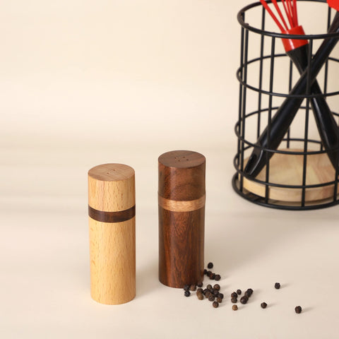 Artistic India salt and pepper set on table showcases balanced contrast.