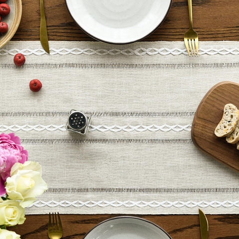 Artoid Mode beige rustic table runner on a festive dining table setting.