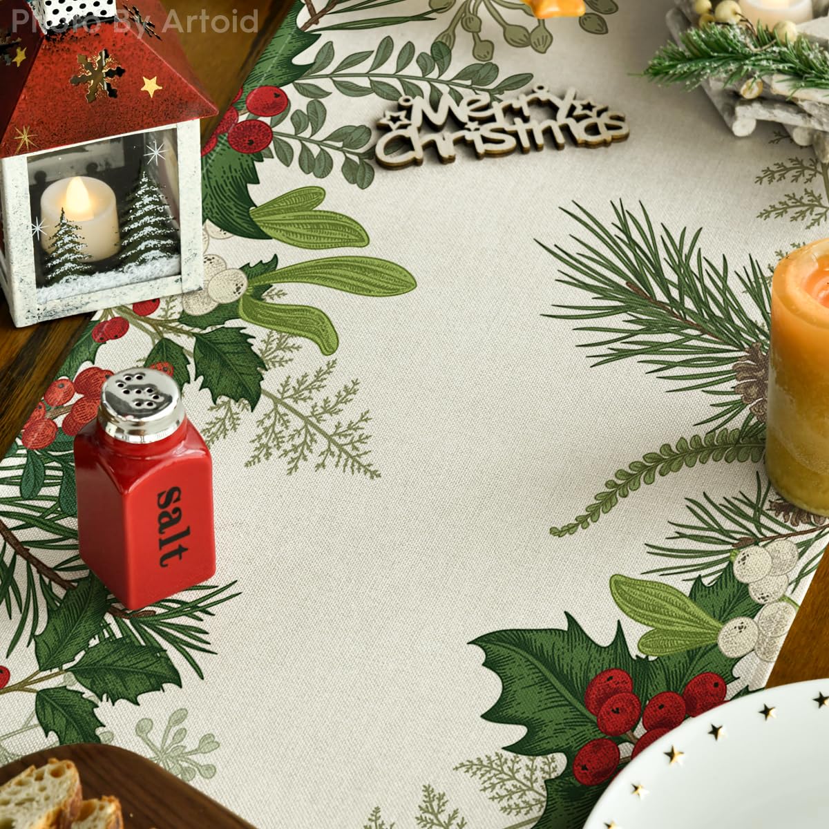 Artoid Mode Holly Pine Cone design enhances Christmas dinner ambiance on table.