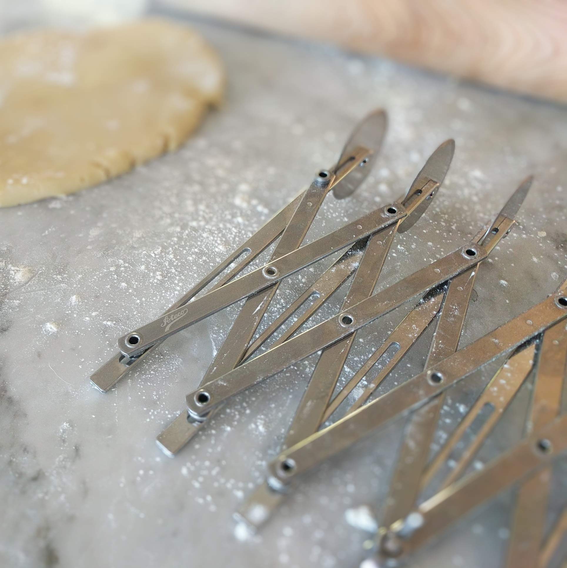 Ateco 5-Wheel Cutter locking device in use for even pastry trimming