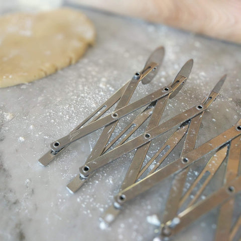 Ateco 5-Wheel Cutter locking device in use for even pastry trimming