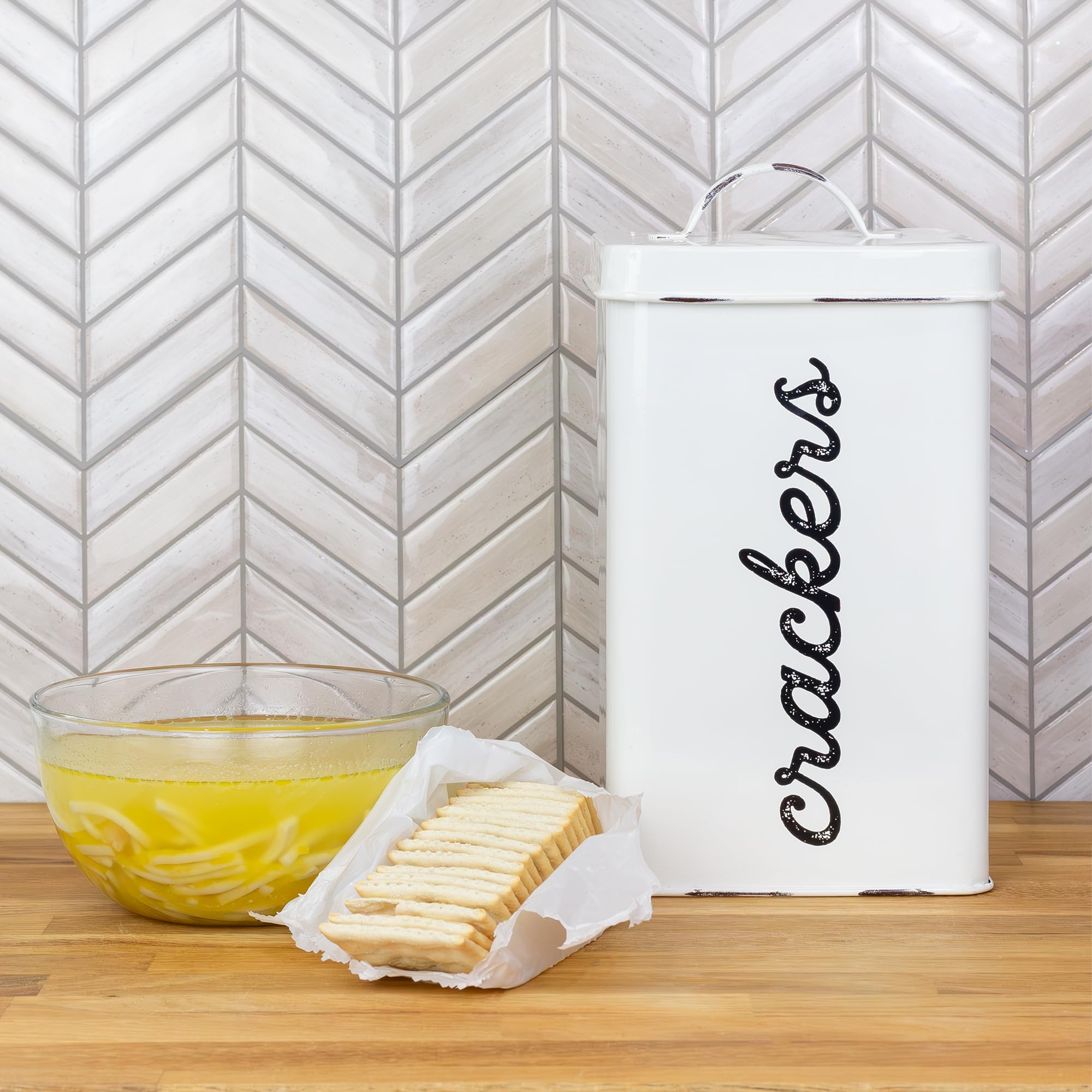 AuldHome Design enamelware cracker canister displayed on kitchen shelf for decorative storage.