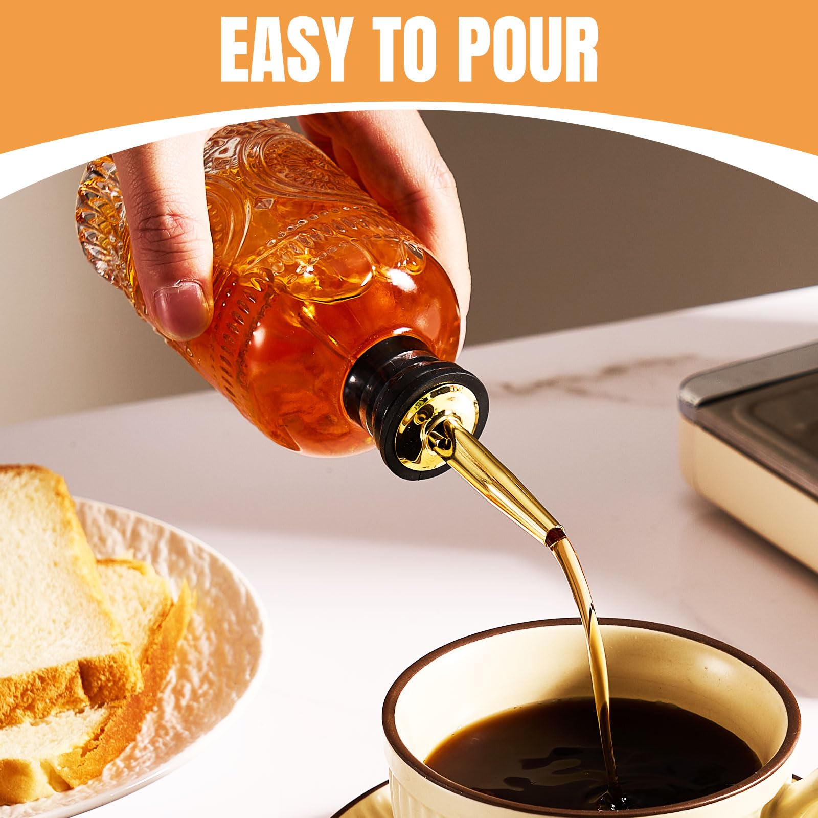 Baalaka glass syrup dispenser with metal pour spout for smooth drizzle.