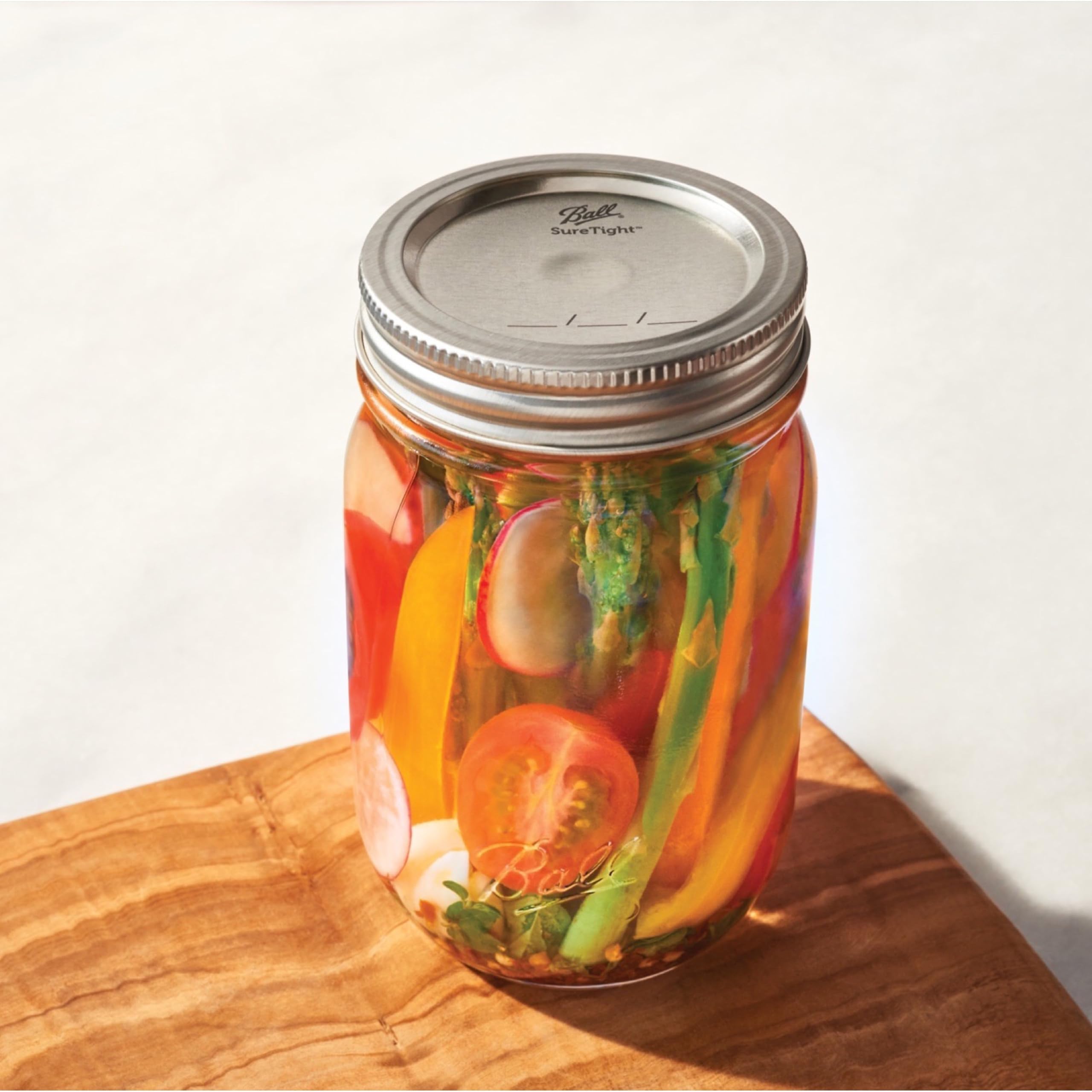 Ball jars in kitchen setup with reliable lids ensuring freshness.