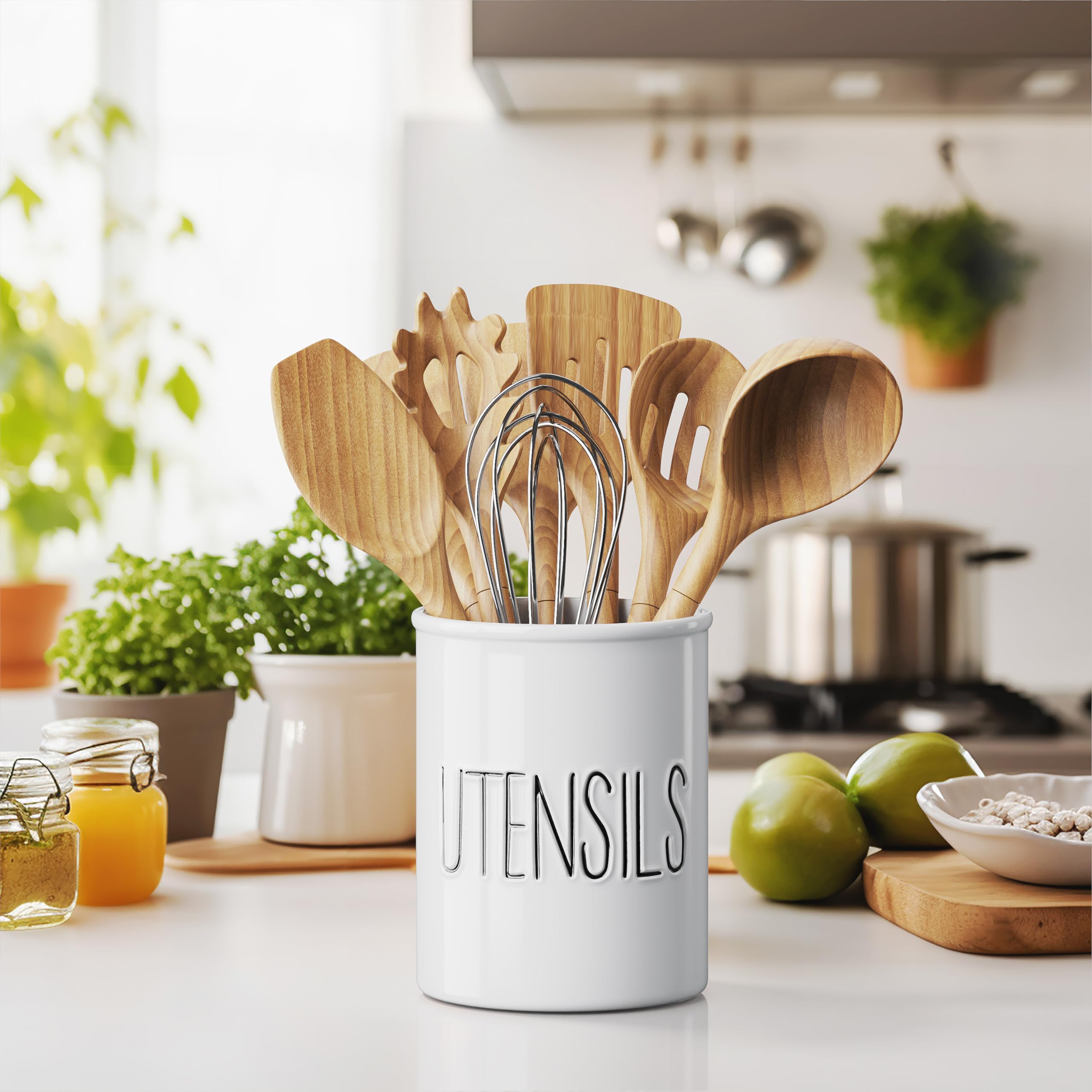 White ceramic utensil crock by Barnyard Designs displaying spoons and whisks neatly.