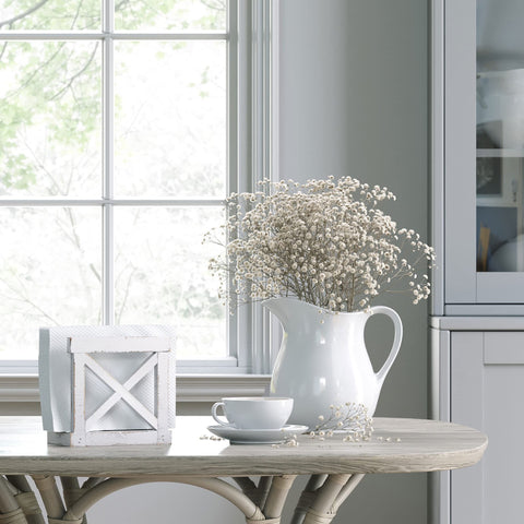 Barnyard Designs white napkin dispenser enhances farmhouse decor on the counter.
