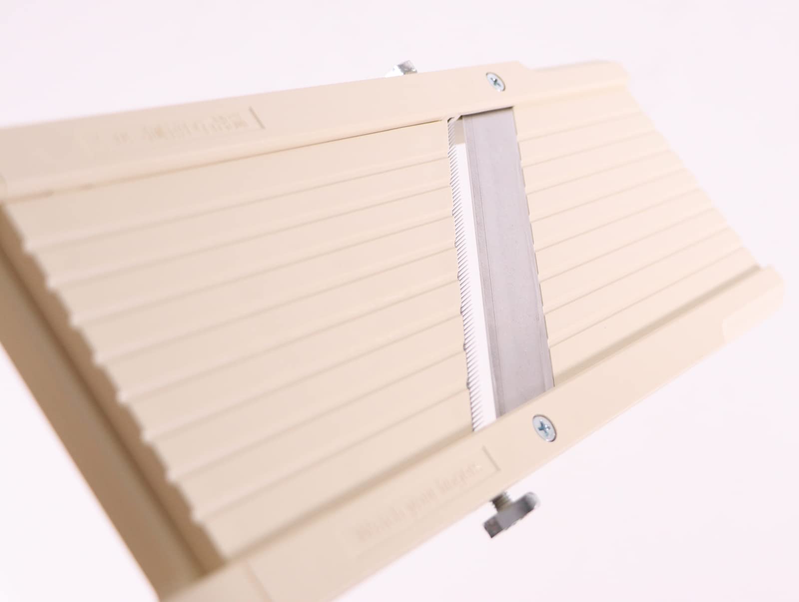 Benriner beige slicer with medium-tooth blade for long strips and stir-fries.