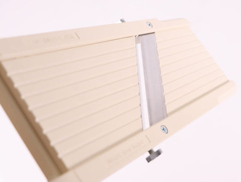 Benriner beige slicer with medium-tooth blade for long strips and stir-fries.