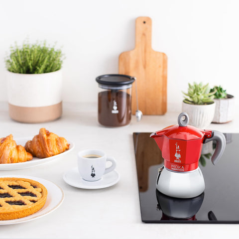 Bialetti Moka Induction lid and handle show iconic moustache branding and easy grip