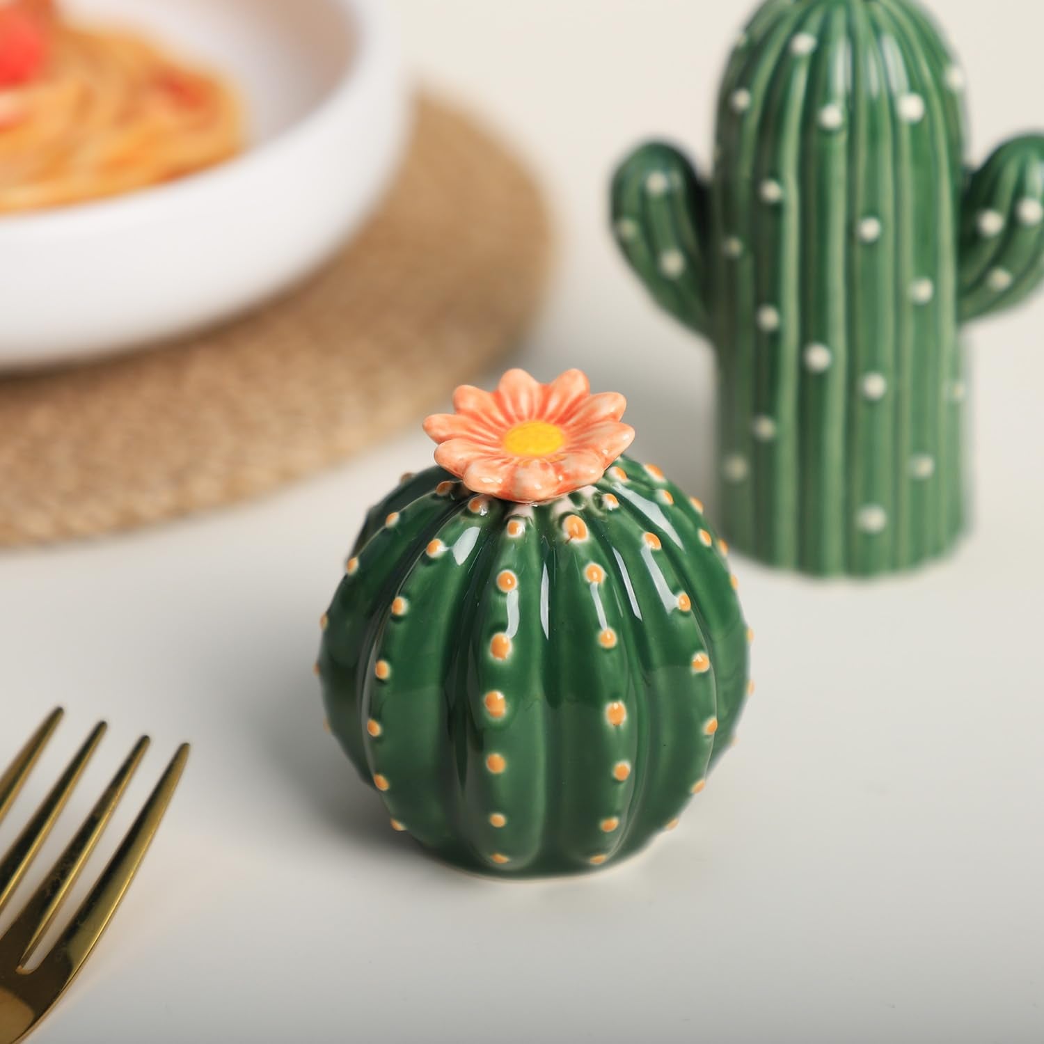 Bicuzat ceramic cactus shakers on dining table as playful decor.