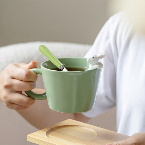 BigNoseDeer kawaii ceramic mug with lid and spoon for convenient sipping.