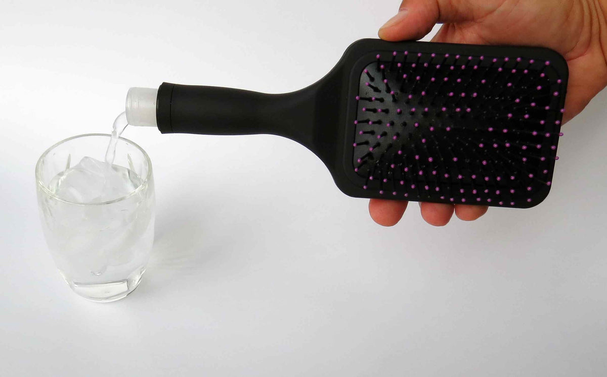 Binocktails Bev-Brush paddle brush with hidden 6 oz flask for discreet on-the-go drinks.