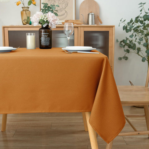 Biscaynebay bronze tablecloth drapes elegantly over a modern dining table