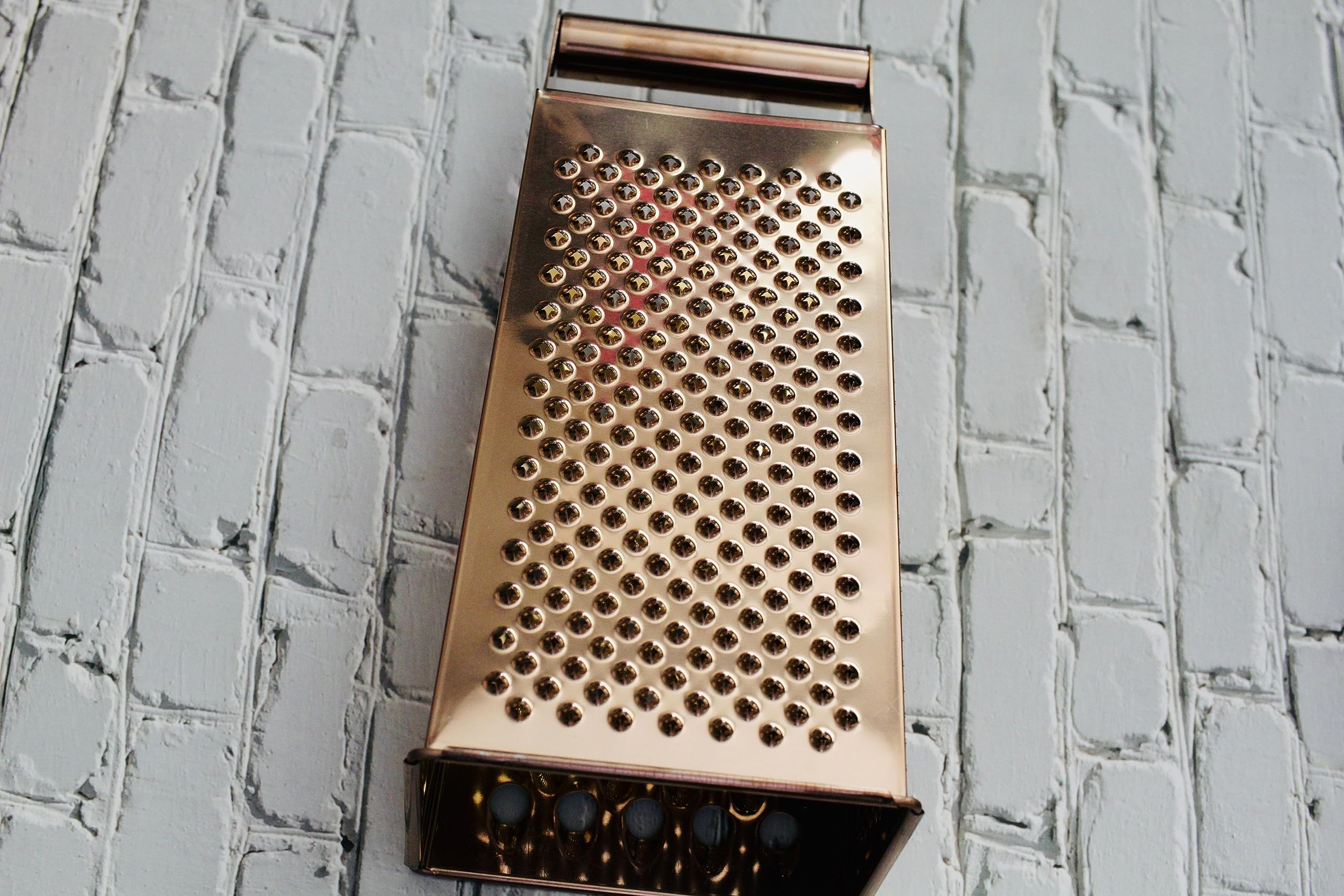 BISDARUN gold grater in action grating ginger into fine strips