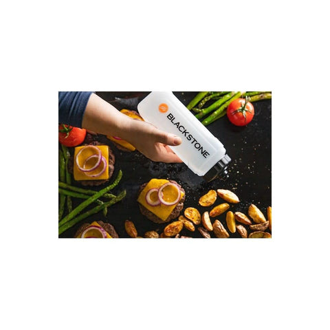 Blackstone bottle in kitchen setup supports quick oil application during grilling.