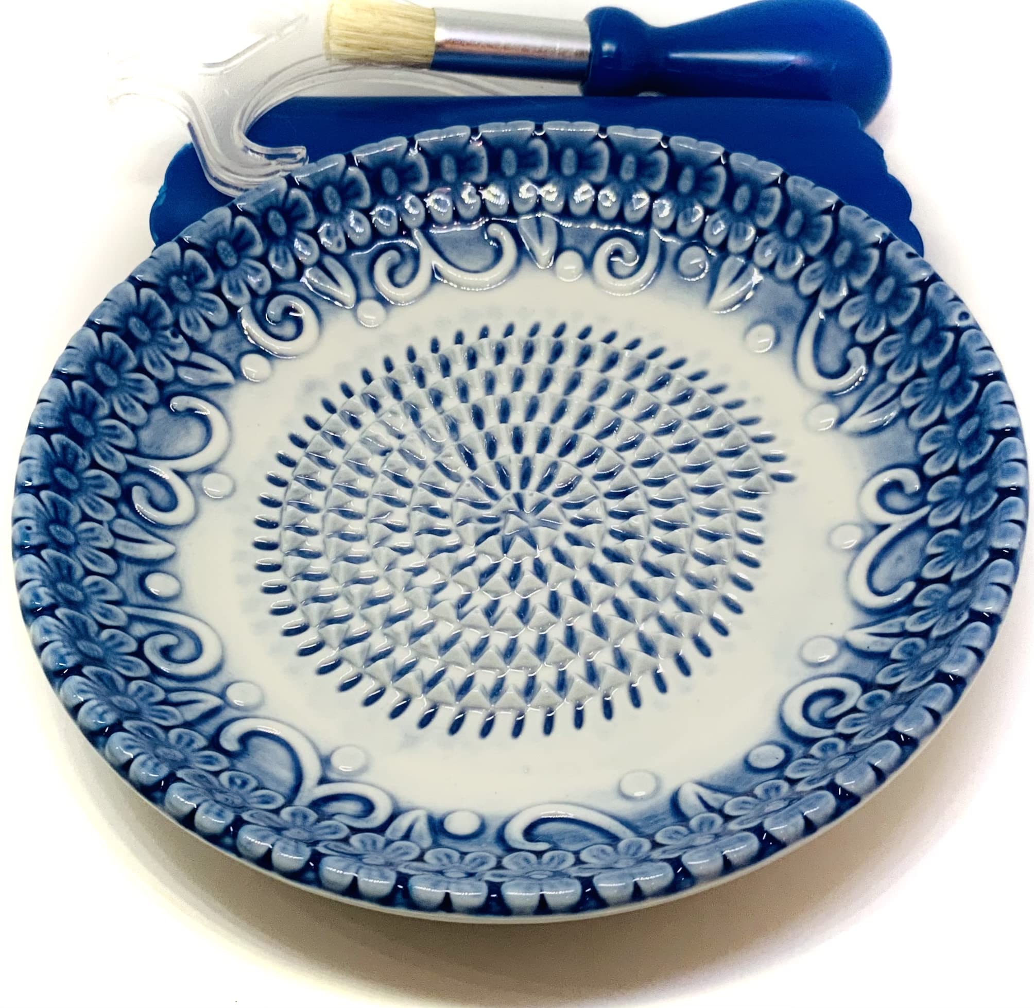 BonCera blue-embossed plate showcases center ridges for fast grating of garlic.