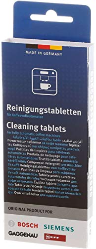 Tablets dissolving in water inside a coffee machine to remove residue.