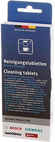 Tablets dissolving in water inside a coffee machine to remove residue.