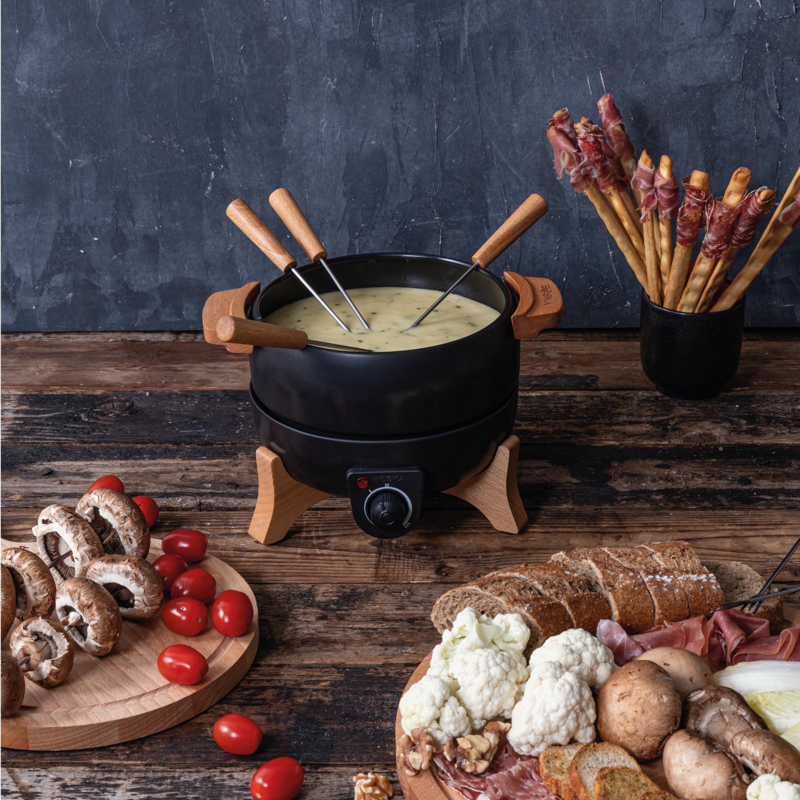 Boska Electric Fondue Set Party 2.3 L in use with cheese fondue highlighting smooth melting and dipping.