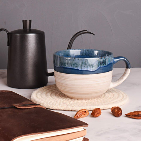Bosmarlin Prussian Blue ceramic mug pair on a desk.