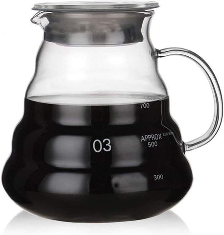 Boxtree 800ml clear glass coffee server held for pouring into cups