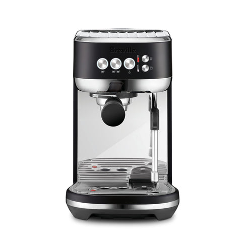 Breville Bambino Plus espresso shot with rich crema in a compact home setup.