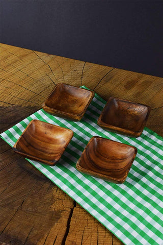 Handmade acacia wood bowls with rich grain textures.