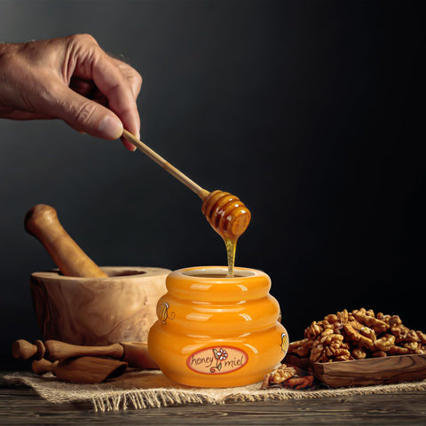 Bee-themed jar enhances farmhouse kitchen decor.