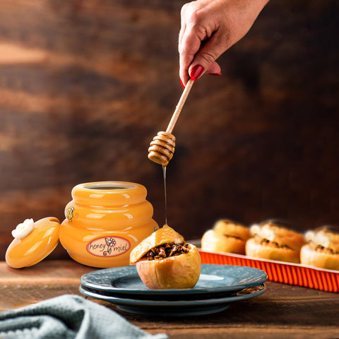 Orange ceramic honey jar ready for tea and toast.