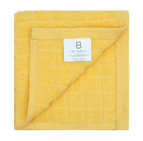 Bumble Towels yellow absorbent towels demonstrate efficient spill wiping.